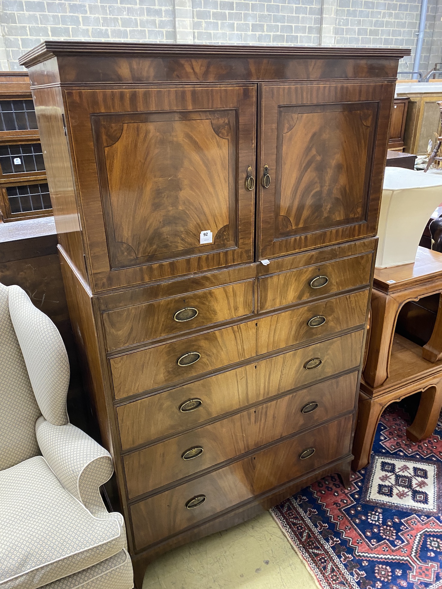 An Edwardian George III style mahogany cupboard on chest, width 106cm, depth 53cm, height 186cm